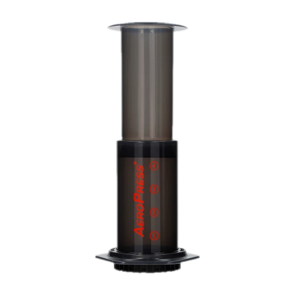 Zaparzacz AeroPress Original w ciemnoszarym kolorze z czerwonym logo. Urządzenie służące do parzenia kawy metodą ciśnieniową, idealne do przygotowania świeżej kawy w domu lub w podróży.