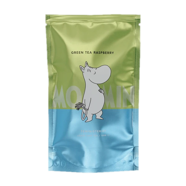 Opakowanie herbaty sypanej Teministeriet Moomin Green Tea Raspberry, 100g, z uroczym motywem Muminka. Zielona herbata o owocowym aromacie malin, idealna do codziennego relaksu. Wyjątkowa mieszanka inspirowana światem Muminków, łącząca świeżość zielonej herbaty z delikatną słodyczą malin.