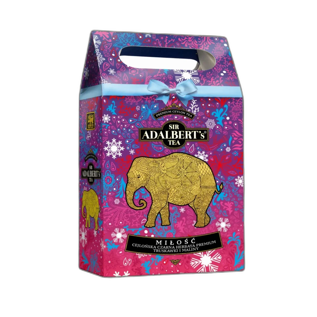 Świąteczne opakowanie Sir Adalbert's Tea Miłość z praktycznym uchwytem, zawierające czarną herbatę cejlońską premium o smaku truskawek i malin. Fioletowo-różowa kolorystyka z eleganckim złotym motywem słonia i świątecznymi ornamentami. Idealny prezent na wyjątkowe okazje lub codzienne chwile relaksu.